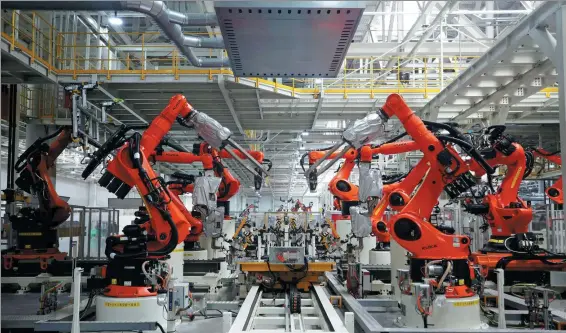  ?? DU XIAOYI / XINHUA ?? Intelligen­t production robots are seen at a workshop of the Volkswagen Anhui MEB (Modular Electric Drive Matrix) plant in Hefei, East China’s Anhui province, on May 29.