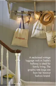  ??  ?? A reclaimed vintage luggage rack in Sadie’s hallway is ideal for family living. The graphic tote bags are from her feminist fashion brand.