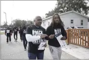  ?? SERKAN GURBUZ — THE ASSOCIATED PRESS ?? Artie Armstrong, left, and Joshua Rasheed canvas the Liberty Hill neighborho­od in North Charleston, South Carolina, along with other We Fight Back campaign activists, to encourage residents to vote in elections.