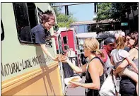  ?? Democrat-Gazette file photo ?? Hungry people fill downtown for the Main Street Food Truck Festival, where 60 food trucks dish up foods to fit every taste.