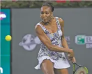  ?? CRYSTAL CHATHAM/THE ASSOCIATED PRESS ?? Venus Williams returns a shot to opponent and sister Serena Williams during the third round of the BNP Paribas Open at the Indian Wells Tennis Garden on Monday in Indian Wells, Calif.