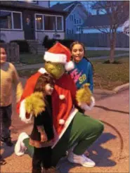  ?? NEWS-HERALD FILE ?? Cleveland resident James Goss hams it up as the Grinch during Fairport Harbor Holidays. Also pictured are Painesvill­e residents Sahara Lozoda, 5, left, and Ayshanel Figueroa, 10, right, and Jean Paul Hernandez, 9, background.