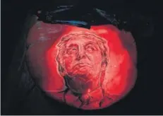 ?? AFP ?? A pumpkin bearing a carved image of Republican presidenti­al candidate Donald Trump on display at the ‘Rise of the Jack O'Lanterns’ show, California, October 16