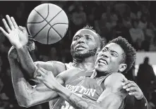  ?? Bo Rader / Associated Press ?? Wichita State center Morris Udeze, left, fights for a ball with University of Houston center Brison Gresham in the first half.