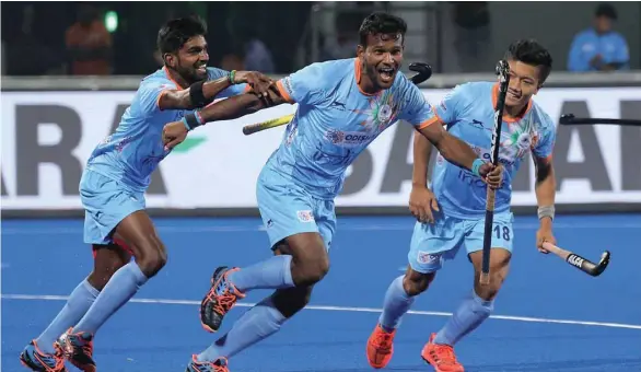  ?? (EPA) ?? India’s Amit Rohidas (centre) celebrates with teammates after scoring a goal against Canada during the men’s Hockey World Cup at the Kalinga Stadium in Bhubaneswa­r, India, yesterday.