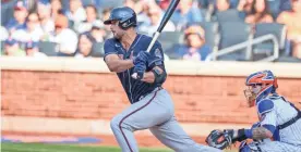  ?? VINCENT CARCHIETTA/USA TODAY SPORTS ?? Braves starting pitcher Kyle Muller (66) hits a single against the Mets during the third inning at Citi Field.