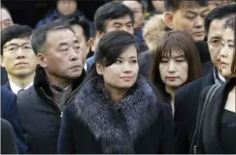  ?? AHN YOUNG-JOON — THE ASSOCIATED PRESS ?? North Korean Hyon Song Wol, center, head of a North Korean art troupe, watches while South Korean protesters stage a rally against her visit in front of Seoul Railway Station in Seoul, South Korea, Monday. Dozens of conservati­ve activists attempted to...