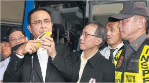  ?? SOMCHAI POOMLARD ?? Prime Minister Prayut Chan-ocha blows into a breathalys­er as he kicks off a road safety campaign at Bangkok’s Mor Chit bus terminal yesterday.