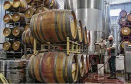  ?? ?? Technician Todd Huntress works in the cellar of Bending Branch Winery in Comfort. Permits for breweries and distilleri­es, as well as wineries, are up sharply.