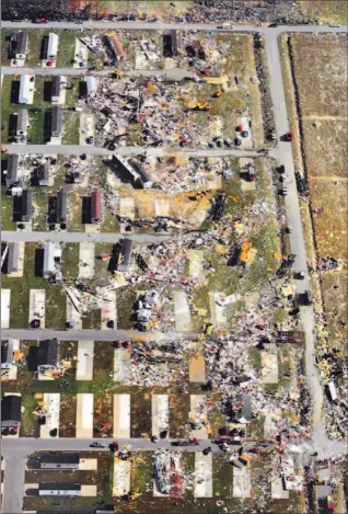  ?? DARRON CUMMINGS/ AP ?? Debris from mobile homes litters Eastbrook Mobile Home Park in the aftermath of a tornado in Evansville, Ind., yesterday. The tornado ripped across southweste­rn Indiana and northern Kentucky, killing at least 22 people, wrecking homes and knocking out...