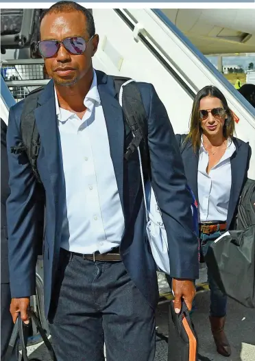  ?? GETTY IMAGES ?? Tiger touches down: Woods arrives in Paris with his girlfriend Erica Herman