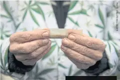  ??  ?? A protester rolls a marijuana joint during a demonstrat­ion outside Parliament in London.