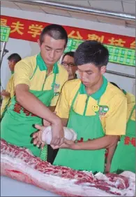  ?? MA JUN / FOR CHINA DAILY ?? Trainees with the butcher school run by Farm Pork No 1 in Shanghai take part in a meat cutting exam. Among the first batch of 60 graduates from the training school, half have bachelor’s degrees.