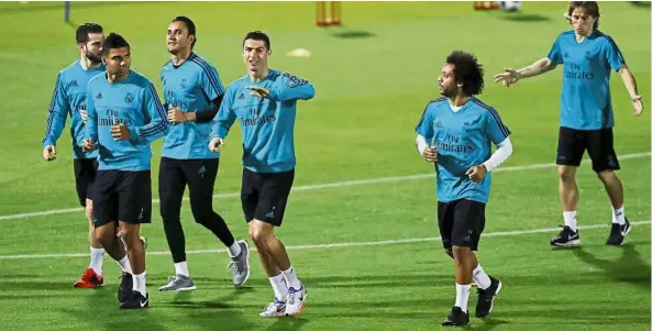  ??  ?? Steady before the bog show: Cristiano Ronaldo (third from right) leading his teammates during a practice session at the New York University Sports Ground in Abu Dhabi. — Reuters