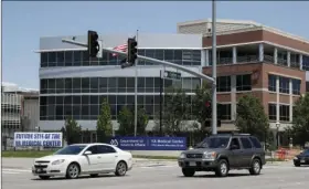  ??  ?? Traffic passes by the campus of the Veterans Administra­tion hospital under constructi­on Thursday in Aurora, Colo. On Thursday the United States Justice Department announced that it has declined to prosecute Veterans Affairs Department executives after...