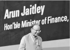  ??  ?? Jaitley attends a seminar on the GST issues during the Vibrant Gujarat investor summit in Gandhinaga­r, India. Jaitley will present the most challengin­g budget of his tenure on Wednesday, as he seeks to appease voters still hurting from the radical...