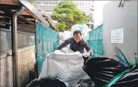  ?? Vic toria Kim Los Angeles Times ?? LEE YONG- GI has to pay to collect plastic waste from apartment complexes in Seoul and shell out more money for recycling centers to take the trash from him.