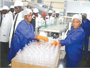  ??  ?? Willowton Zimbabwe female workers sort out cooking oil bottles at the bottle manufactur­ing plant line
