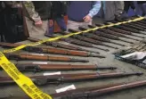  ?? Paul Chinn / The Chronicle 2016 ?? A vendor displays rifles at a Cow Palace gun show in 2016. Some lawmakers are trying to ban such events and change Cow Palace management.