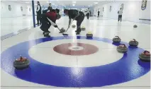  ??  ?? Members of the Laval sur Lac curling team sweep one of their rocks into the house at the Longue- Pointe Curling Club. Dave Sidaway/ files