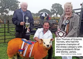  ?? TRAP AGRICULTUR­AL SHOW ?? Wyn Thomas of Greynor, Tycroes, who had the supreme champion of the sheep category with show presidents Brian and Shirley James.