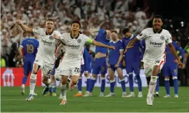  ?? ?? The Eintracht Frankfurt players run towards Rafael Borré after the Colombian’s penalty sealed a 5-4 shootout win over Rangers in the Europa League final. Photograph: Susana Vera/Reuters