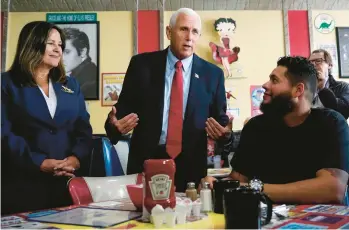  ?? CHARLES KRUPA/AP ?? Former Vice President Mike Pence, center, and his wife, Karen, chat June 9 with diner patrons in Derry, N.H.