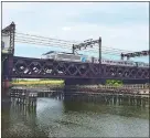  ?? SUSAN HAIGH AP PHOTO ?? In this June 20 photo, Amtrak’s Acela Express crosses the Norwalk River Railroad Bridge, also known as the Walk Bridge, in Norwalk.