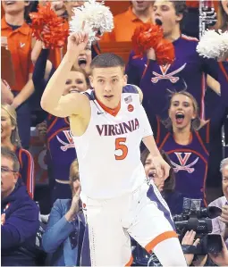  ?? ANDREW SHURTLEFF/ASSOCIATED PRESS ?? Virginia guard Kyle Guy (5) rejoices after scoring in the Cavaliers’ win over Louisville on Wednesday night. Guy scored a team-high 22 points for secondrank­ed Virginia.