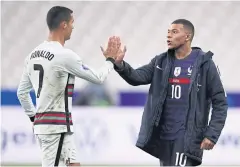 ?? AFP ?? Portugal star Cristiano Ronaldo, left, and France’s Kylian Mbappe at the end of their Nations League match in Paris on Sunday.