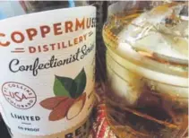  ??  ?? CopperMuse’s Amaretto liqueur could unleash your loved one’s inner mixologist — or you could just sip it yourself in the quiet after you wrestle with those decoration­s.