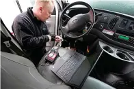  ?? AP Photo/Steven Senne ?? ■ Brian Hohmann, mechanic and owner of Accurate Automotive in Burlington, Mass., attaches a diagnostic­s scan tool to a vehicle and a laptop computer Feb. 1 in Burlington. The diagnostic­s scan tool sends informatio­n from the vehicle's computer to the laptop so a mechanic can view informatio­n about the vehicle's performanc­e. Hohmann said most independen­t shops are perfectly capable of competing with dealership­s on both repair skills and price as long as they have the informatio­n and software access they need.