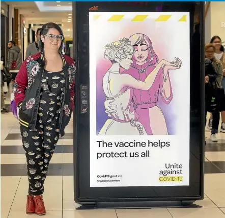  ?? KEVIN STENT/STUFF ?? Wellington-based illustrato­r Jem Yoshioka with a digital billboard at Queensgate in Lower Hutt featuring her illustrati­on for the country’s Covid-19 vaccinatio­n campaign