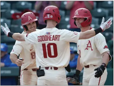  ?? (NWA Democrat-Gazette/Andy Shupe) ?? Arkansas’ Matt Goodheart is met at home plate by teammates Braydon Webb (left) and Cayden Wallace after hitting a two-run home run in the sixth inning of the Razorbacks’ victory over Memphis on Wednesday at Baum-Walker Stadium in Fayettevil­le. Goodheart finished 4 of 5 from the plate. See more photos at arkansason­line.com/325basebal­l.