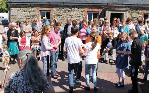  ??  ?? Crowds watch as children take part in the dancing during the cos cos festival in Rathcormac last Sunday.