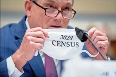  ?? AP-Andrew Harnik ?? Census Bureau Director Steven Dillingham holds up his mask with the words “2020 Census” as he testifies before a House Committee on Oversight and Reform hearing on the 2020 Census on Capitol Hill in Washington.