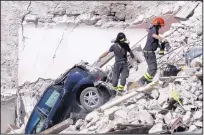  ??  ?? GREGORIO BORGIA/ASSOCIATED PRESS Rescuers make their way through destroyed houses as they search for survivors of Wednesday’s earthquake in Pescara Del Tronto, Italy, on Thursday.