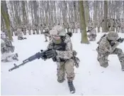  ?? EFREM LUKATSKY/AP ?? Members of Ukraine’s volunteer military units train in a city park Saturday in Kyiv, Ukraine.