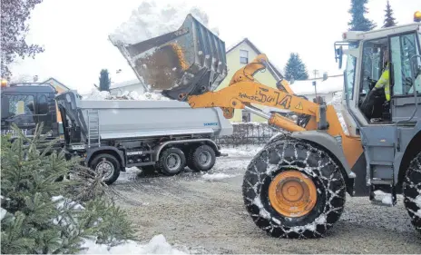  ?? FOTOS: WALTER SCHMID ?? An unübersich­tlichen Stellen wird der Schnee mit dem Schaufella­der auf Lkw verladen und aus der Stadt abgefahren.