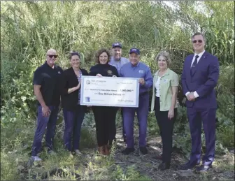  ?? Courtesy photo ?? Assemblywo­man Pilar Schiavo, D- Chatsworth (center left), presented a $1 million check to the Santa Clarita Valley Water Agency on Sunday to support the removal of Arundo from the Santa Clara River watershed.