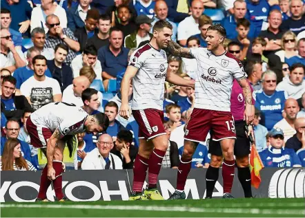  ??  ?? In-form: Burnley’s Sam Vokes (centre) celebrates with teammate Jeff Hendrick after scoring their third goal against Chelsea at Stamford Bridge yesterday. Burnley won 3-2. — Reuters