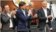  ?? DORAL CHENOWETH III / COLUMBUS DISPATCH ?? Ratmir Timashev (right), an Ohio State alumus, is congratula­ted Thursday for a record $110 million donation to the university for a center and program focused on software innovation.