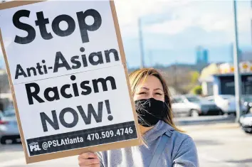  ?? MEGAN VARNER/GETTY ?? An activist demonstrat­es against violence toward women and Asians on Thursday in Atlanta. A 21-year-old man was arrested after a series of shootings at three Atlanta-area spas left eight dead, including six women identified as Asian.