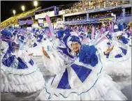  ?? WANG TIANCONG / XINHUA ?? Feather-festooned dancers bring a blaze of color to a venue in Rio de Janeiro as the Brazilian city’s Carnival explodes into life on April 20. This year’s celebratio­ns follow two years of pandemic-induced cancellati­ons.