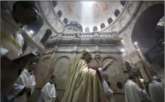  ?? PHOTO/SEBASTIAN SCHEINER ?? In this April 16 file photo, Latin Patriarch of Jerusalem Pierbattis­ta Pizzaballa (center) walks with Christian clergymen on Easter Sunday at the Church of the Holy Sepulchre in Jerusalem. In a joint statement, the leaders of the major Christian sects...