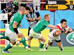  ??  ?? Japan's wing Kenki Fukuoka (R) dives and scores a try during the Japan 2019 Rugby World Cup Pool A match against Ireland - AFP