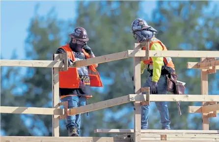  ?? Mark J. Terrill, The Associated Press ?? Constructi­on workers talk at a USA Properties Fund site Tuesday in Simi Valley, Calif.