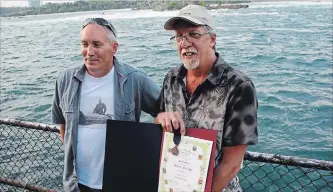  ?? JOHN LAW THE NIAGARA FALLS REVIEW ?? Kip Finn, left, great grandson of famed Niagara riverman William (Red) Hill Sr., along with Hill's grandson Dan Hill, attend a ceremony marking the 100th anniversar­y of the iron scow rescue.