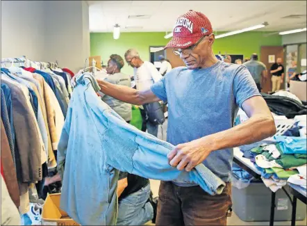  ??  ?? Air Force veteran Frank Gibbs picks out a jacket in the clothing area Friday during the annual Sooner Stand Down, an event bringing together services and resources for low income and homeless veterans, at the Homeless Alliance's WestTown Homeless Resource Campus, 1724 NW 4 St., in Oklahoma City. [NATE BILLINGS/ THE OKLAHOMAN]