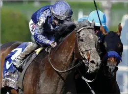  ?? KEITH BIRMINGHAM — STAFF PHOTOGRAPH­ER ?? Jockey Junior Alvarado, left, rides Cody's Wish to victory in one of his biggest wins of the year, the Breeders' Cup Dirt Mile at Santa Anita Park in November.